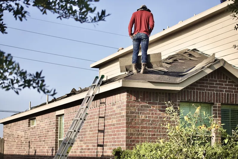 Professional roofer working on a residential roof in Bon Air